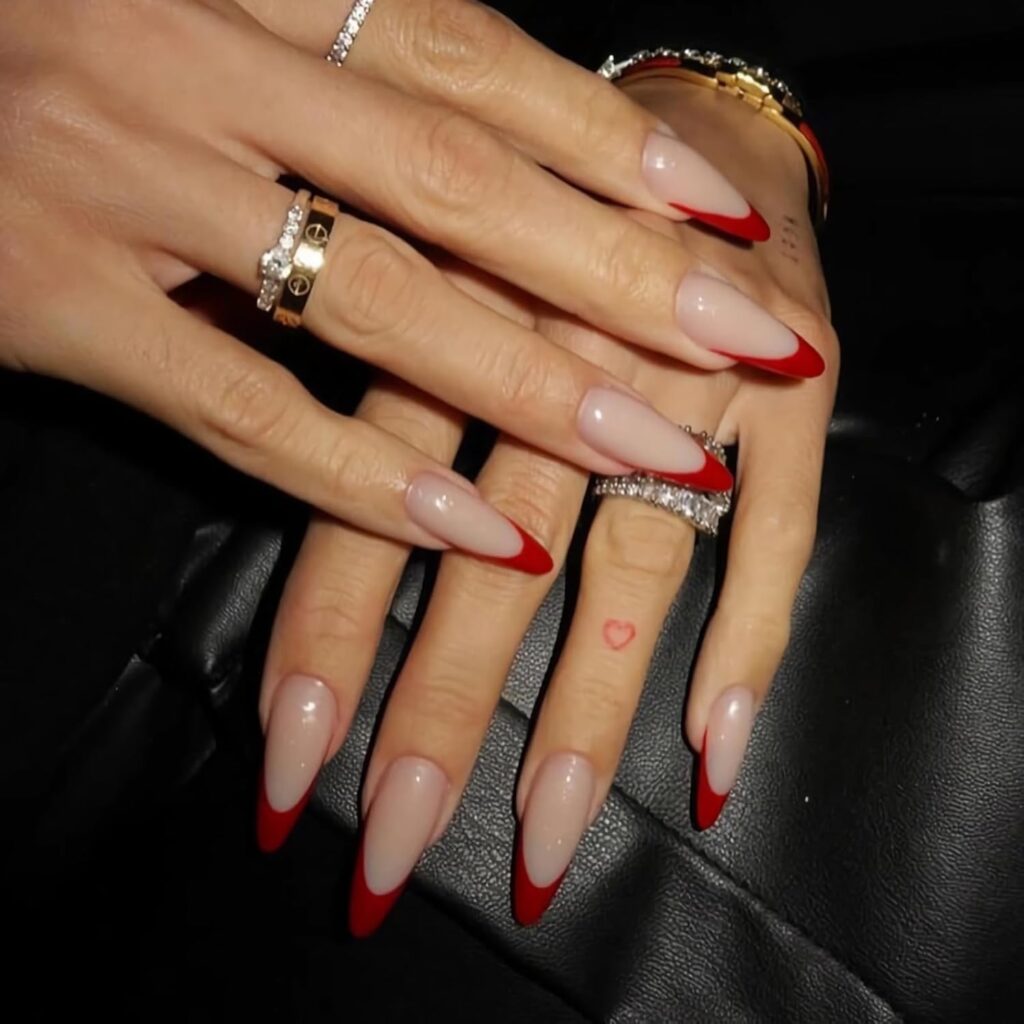 Minimal red French tips offer a refined take on classic Valentine Nails